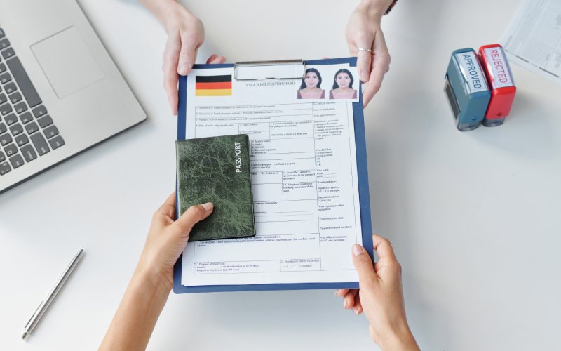 A person holding visa documents of Germany.